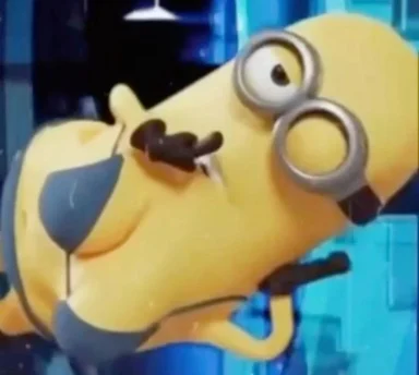 Blurry low-quality screenshot of a yellow cartoon minion lying sideways with goggles and one visible eye