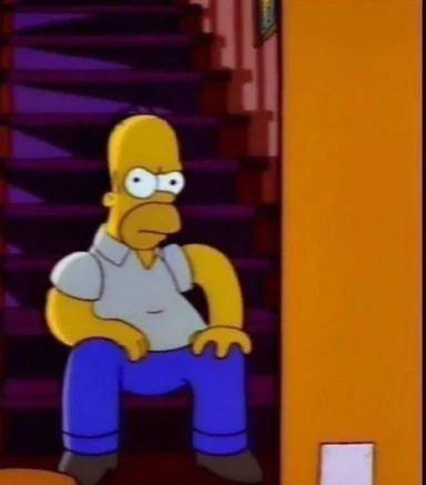 Cartoon screenshot of Homer Simpson sitting on a dim staircase with a glum, brooding expression